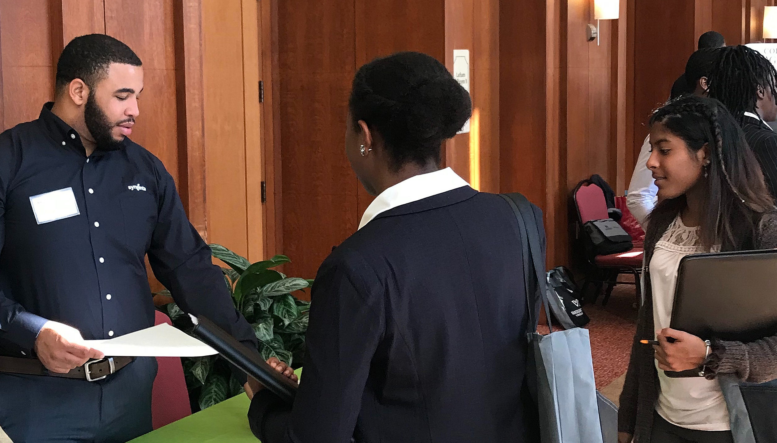 Students visiting with agriculture companies at diversity conference.